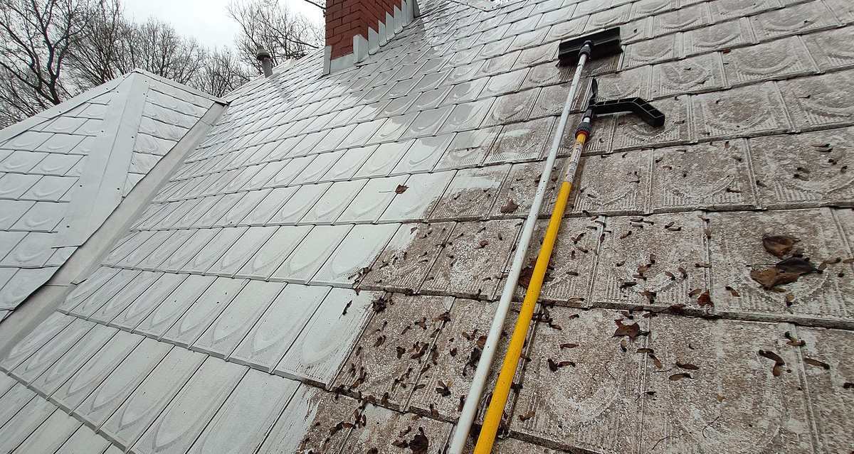 Metal roof being cleaned